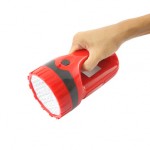 hand holding a large red flashlight