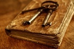 Old metal keys on vintage book.